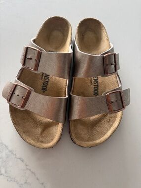 Birkenstock women’s Arizona Metallic Rose Gold Two-Strap Sandal